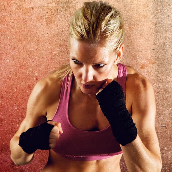 Mixed Martial Arts Lessons for Adults in San Antonio TX - Lady Kickboxing Focused Background