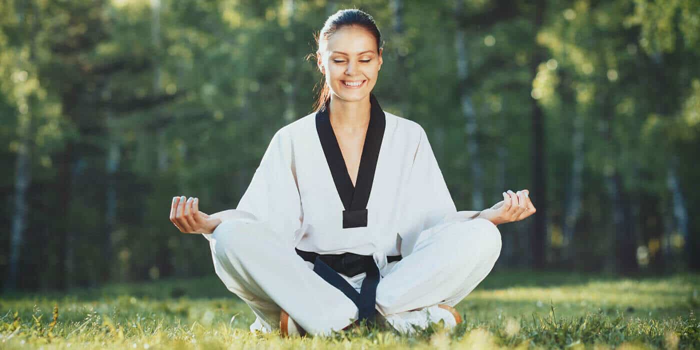 Martial Arts Lessons for Adults in San Antonio TX - Happy Woman Meditated Sitting Background